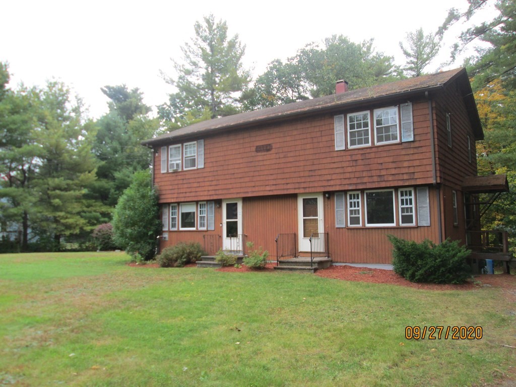 66 South Road Londonderry, NH 03053 - Photo 1 of 21 a front view of house with yard and green space