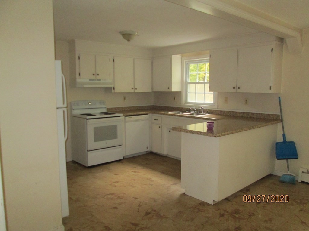 66 South Road Londonderry, NH 03053 - Photo 14 of 21 a kitchen with stainless steel appliances granite countertop a sink stove and cabinets