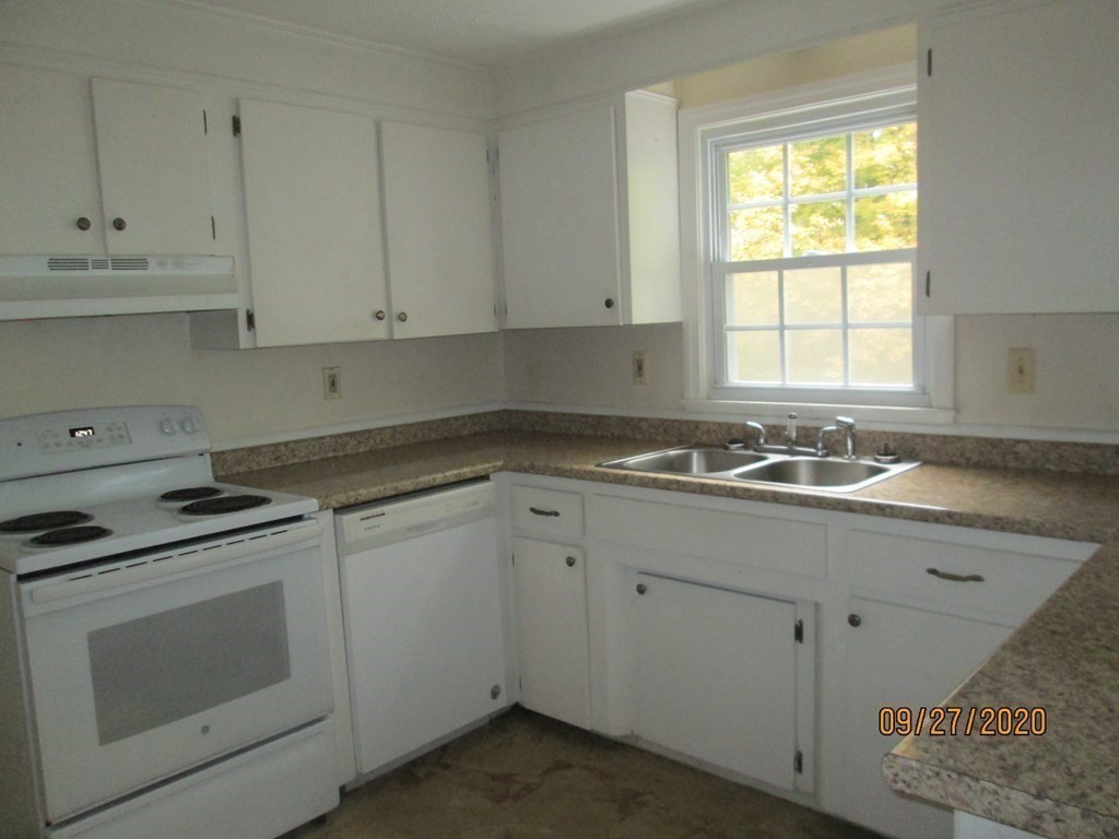 66 South Road Londonderry, NH 03053 - Photo 15 of 21 a kitchen with cabinets appliances a sink and a window