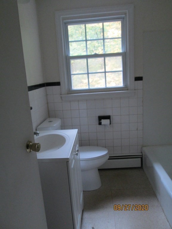 66 South Road Londonderry, NH 03053 - Photo 17 of 21 a bathroom with a sink toilet and window