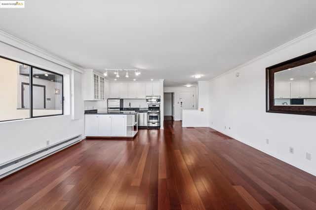 a view of kitchen with wooden floor and electronic appliances