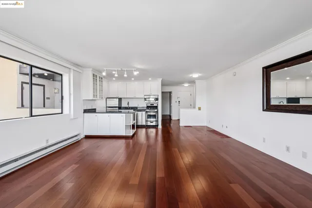 a view of kitchen with wooden floor and electronic appliances