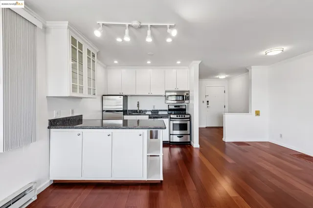 a view of kitchen with furniture and wooden floor