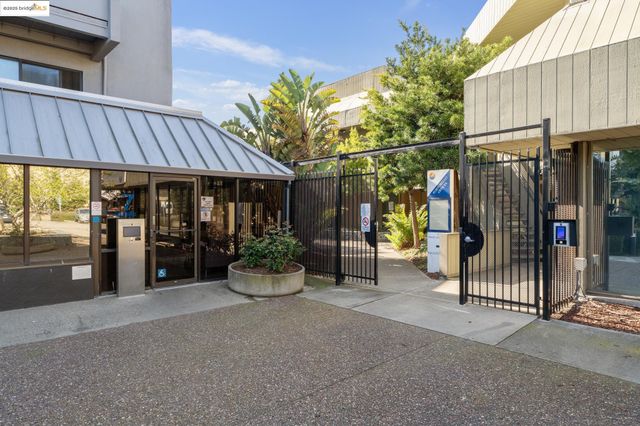 a view of a patio with table and chairs under an umbrella