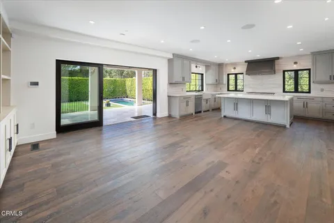 a view of kitchen with stainless steel appliances refrigerator sink and stove