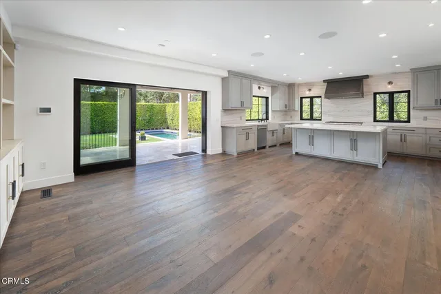 a view of kitchen with stainless steel appliances refrigerator sink and stove