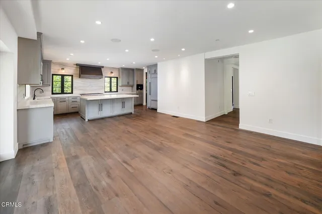 a kitchen with a cabinets stove top oven and sink