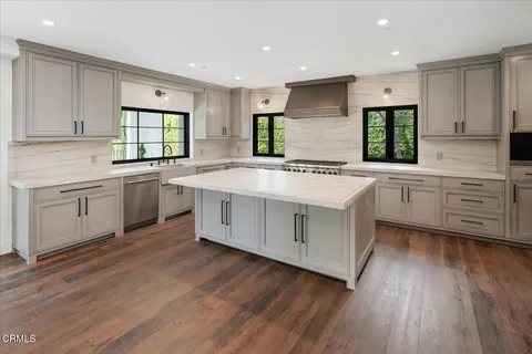 a kitchen with a stove a sink and a refrigerator