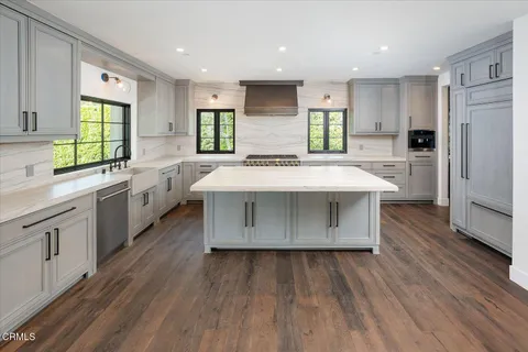 a kitchen with a sink stove and cabinets