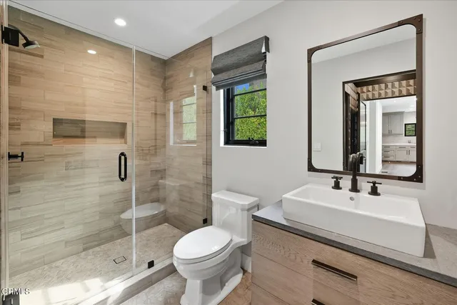 a view of empty room with wooden floor and window