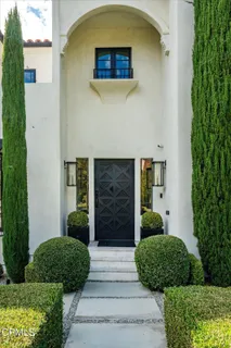 a view of a hallway with wooden floor and entryway