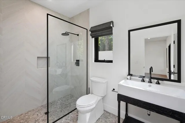 an aerial view of a house with a garden and lake view