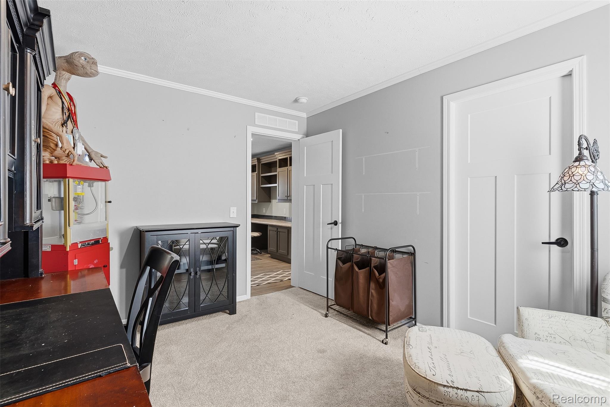 6450 Prince Boulevard Fenton, MI 48430 - Photo 25 of 31 Neutral-toned room with light gray walls, white trim, and light beige carpet