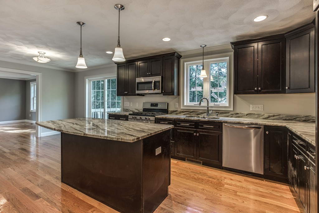 a kitchen with stainless steel appliances granite countertop a sink stove and a granite counter top