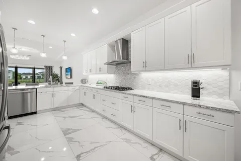 a large bathroom with a granite countertop double vanity sink a mirror and a shower
