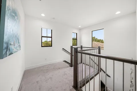 an aerial view of residential houses with outdoor space and lake view