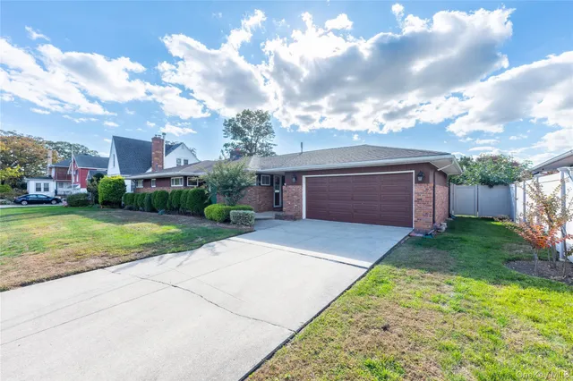 a view of backyard of house with green space
