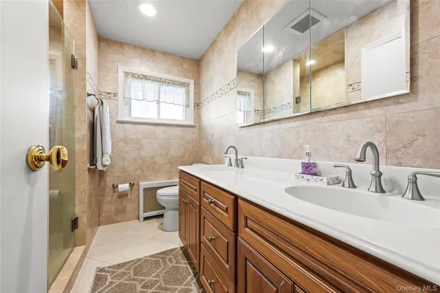 a bathroom with a sink double vanity and a shower