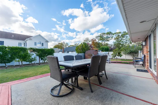 a view of a patio with table and chairs and potted plants