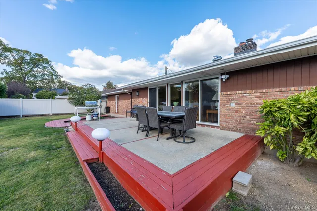 a swimming pool with outdoor seating and yard