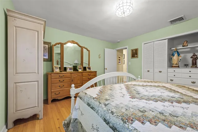 a view of a bedroom with cabinet and mirror