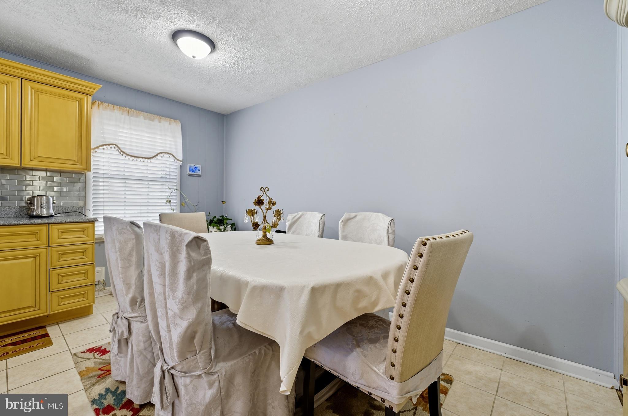 1311 Tenbrook Road Odenton, MD 21113 - Photo 17 of 37 a view of a dining room with furniture and a window