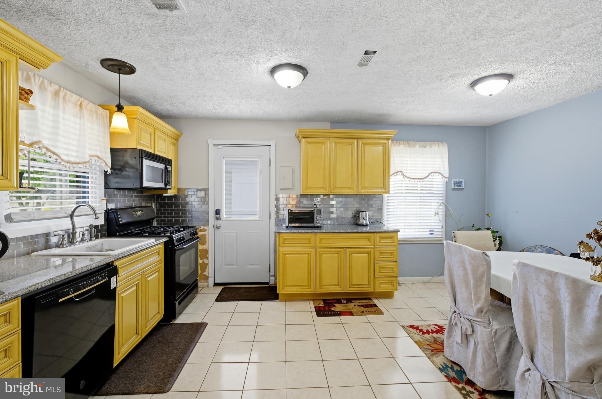 1311 Tenbrook Road Odenton, MD 21113 - Photo 19 of 37 a kitchen with a sink a stove top oven a counter space and cabinets