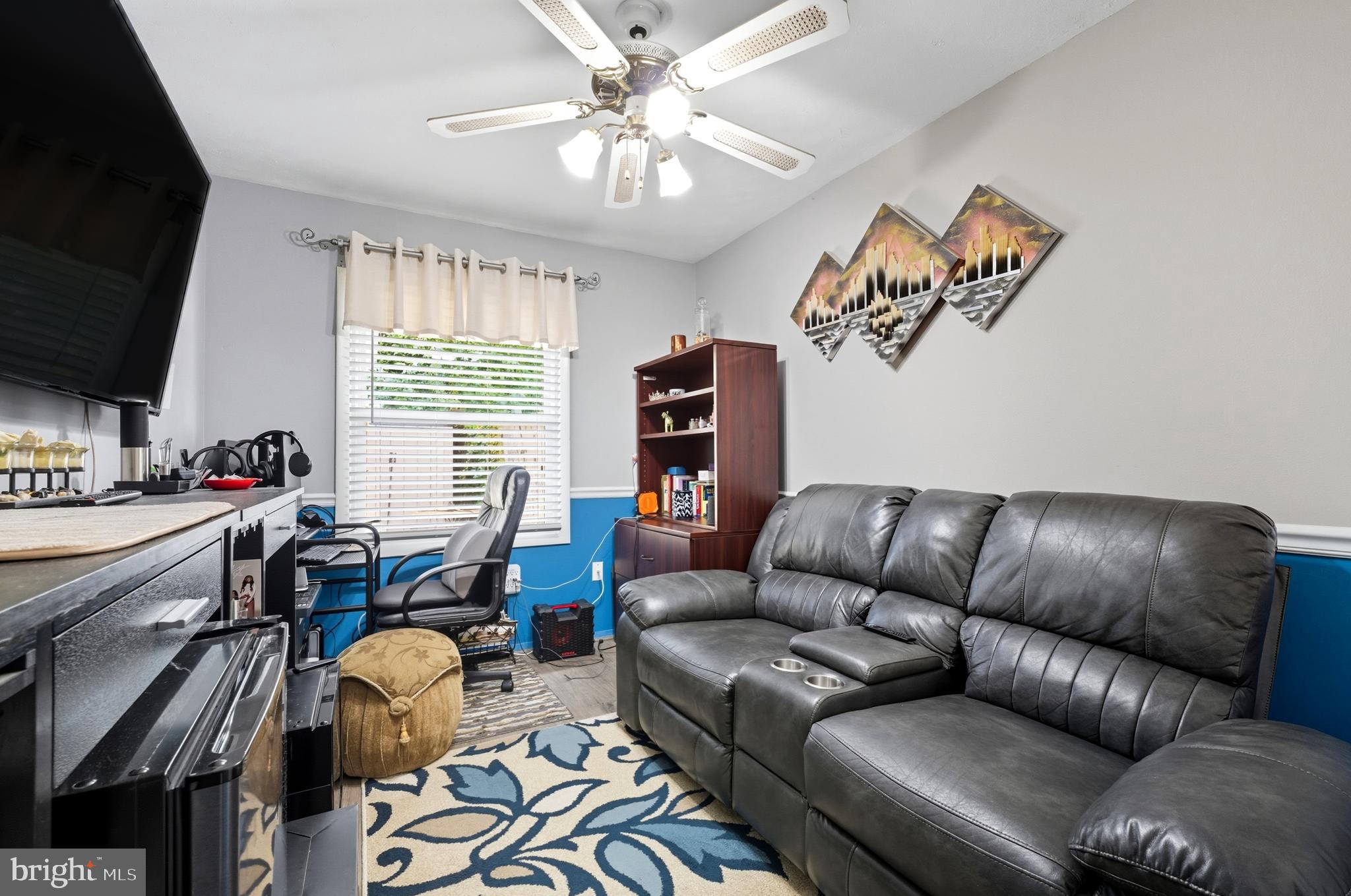1311 Tenbrook Road Odenton, MD 21113 - Photo 34 of 37 a living room with furniture a flat screen tv and a window