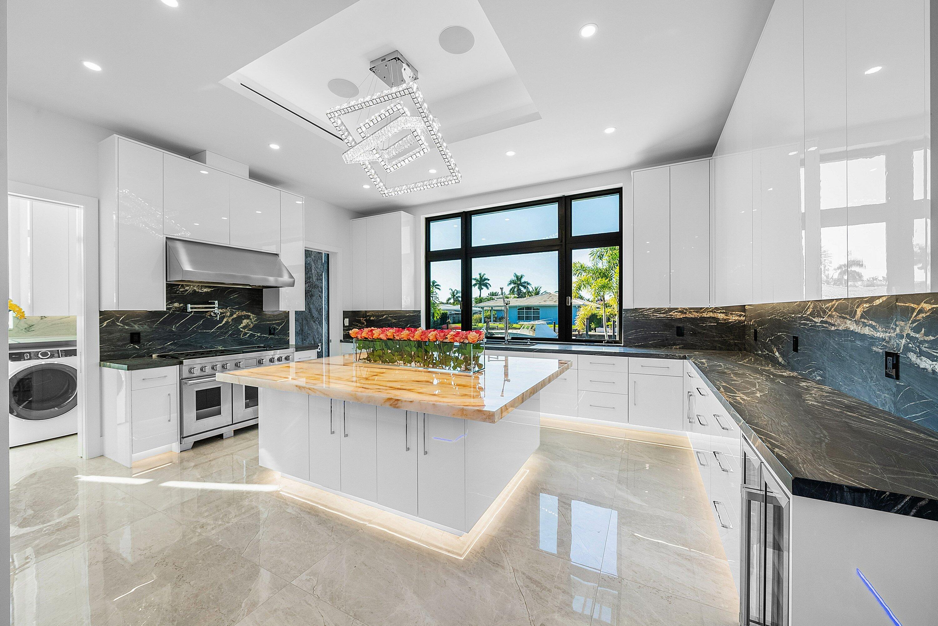 2650 Northeast 48th Court Lighthouse Point, FL 33064 - Photo 20 of 86 a large white kitchen with a large window