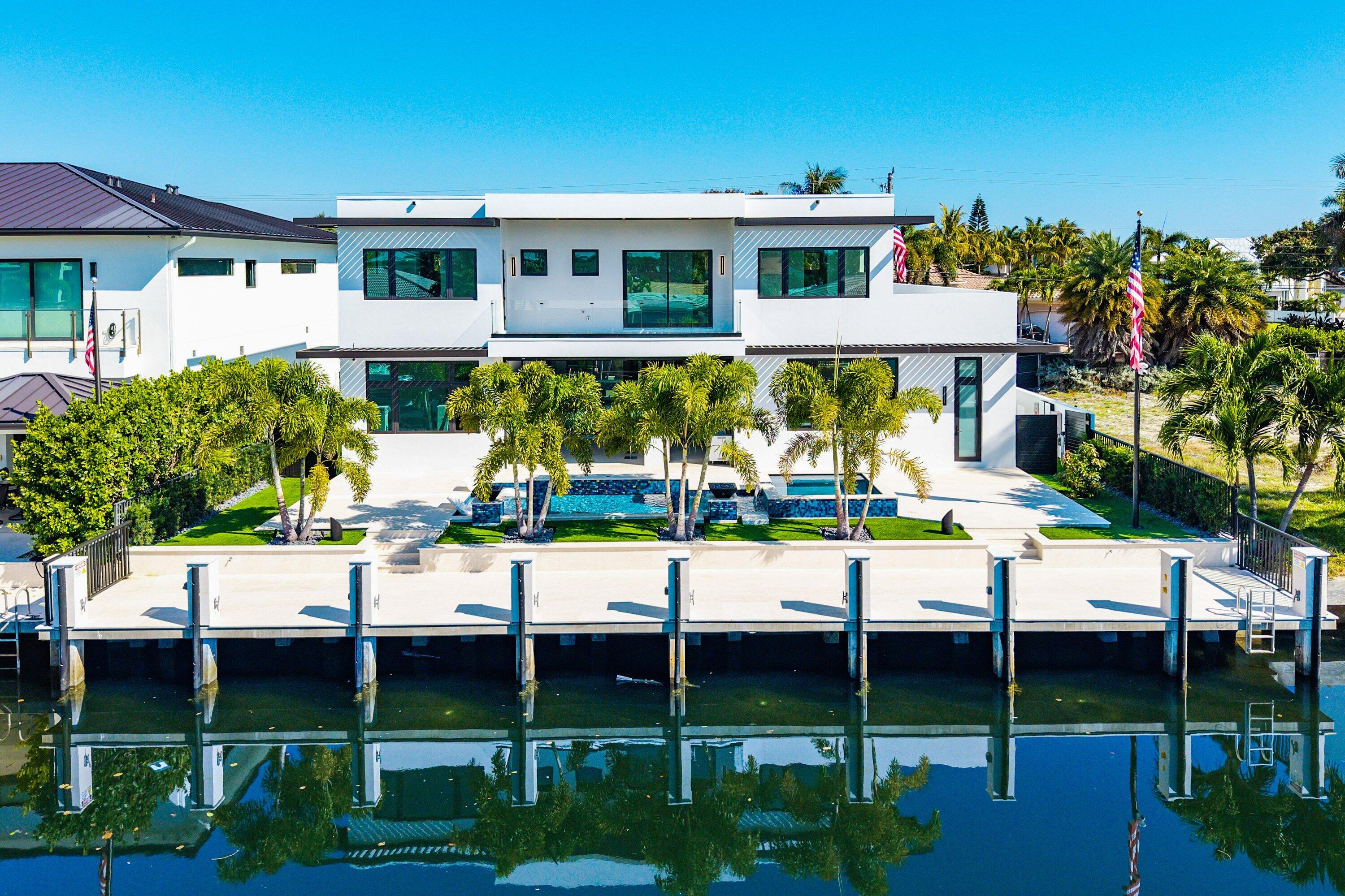 2650 Northeast 48th Court Lighthouse Point, FL 33064 - Photo 2 of 86 a view of a chairs and table in a patio