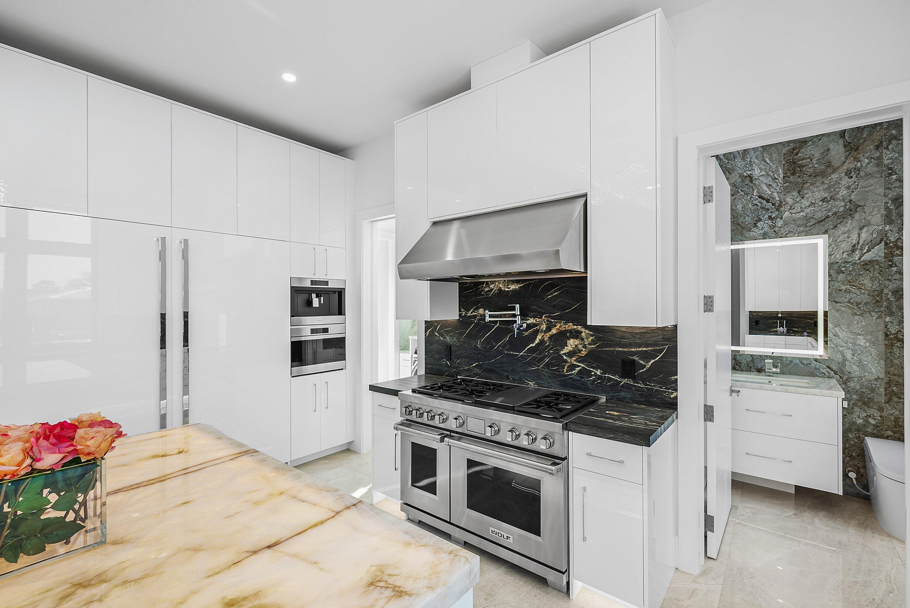 2650 Northeast 48th Court Lighthouse Point, FL 33064 - Photo 23 of 86 a kitchen with stainless steel appliances granite countertop a stove and a refrigerator