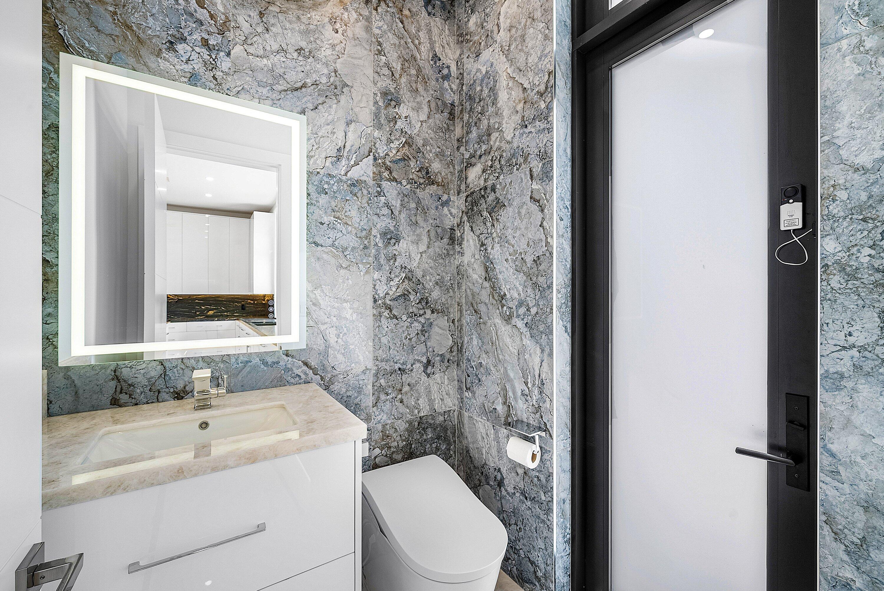 2650 Northeast 48th Court Lighthouse Point, FL 33064 - Photo 24 of 86 a bathroom with a granite countertop sink toilet and shower