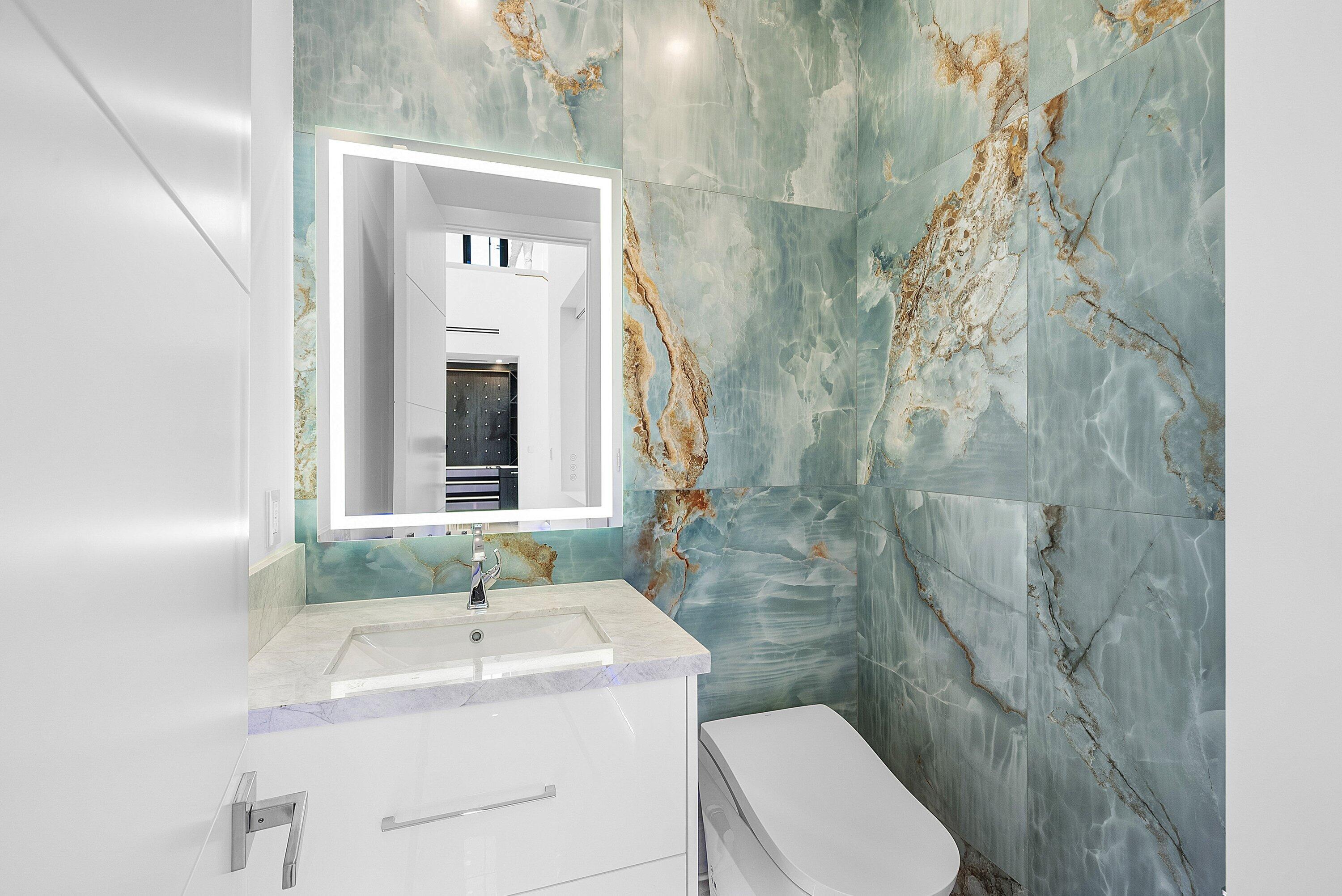 2650 Northeast 48th Court Lighthouse Point, FL 33064 - Photo 27 of 86 a bathroom with a sink a toilet and shower