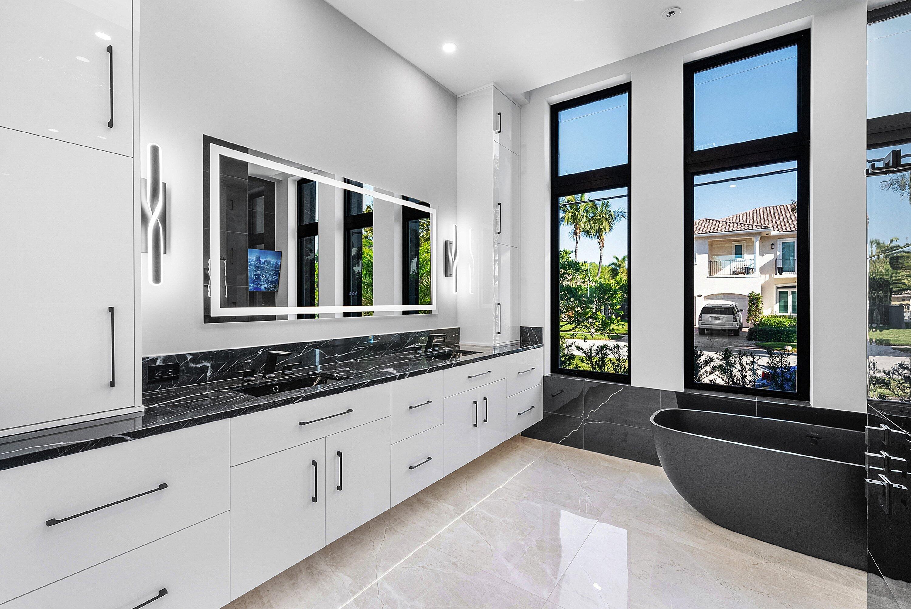 2650 Northeast 48th Court Lighthouse Point, FL 33064 - Photo 33 of 86 a large white kitchen with granite countertop a large window