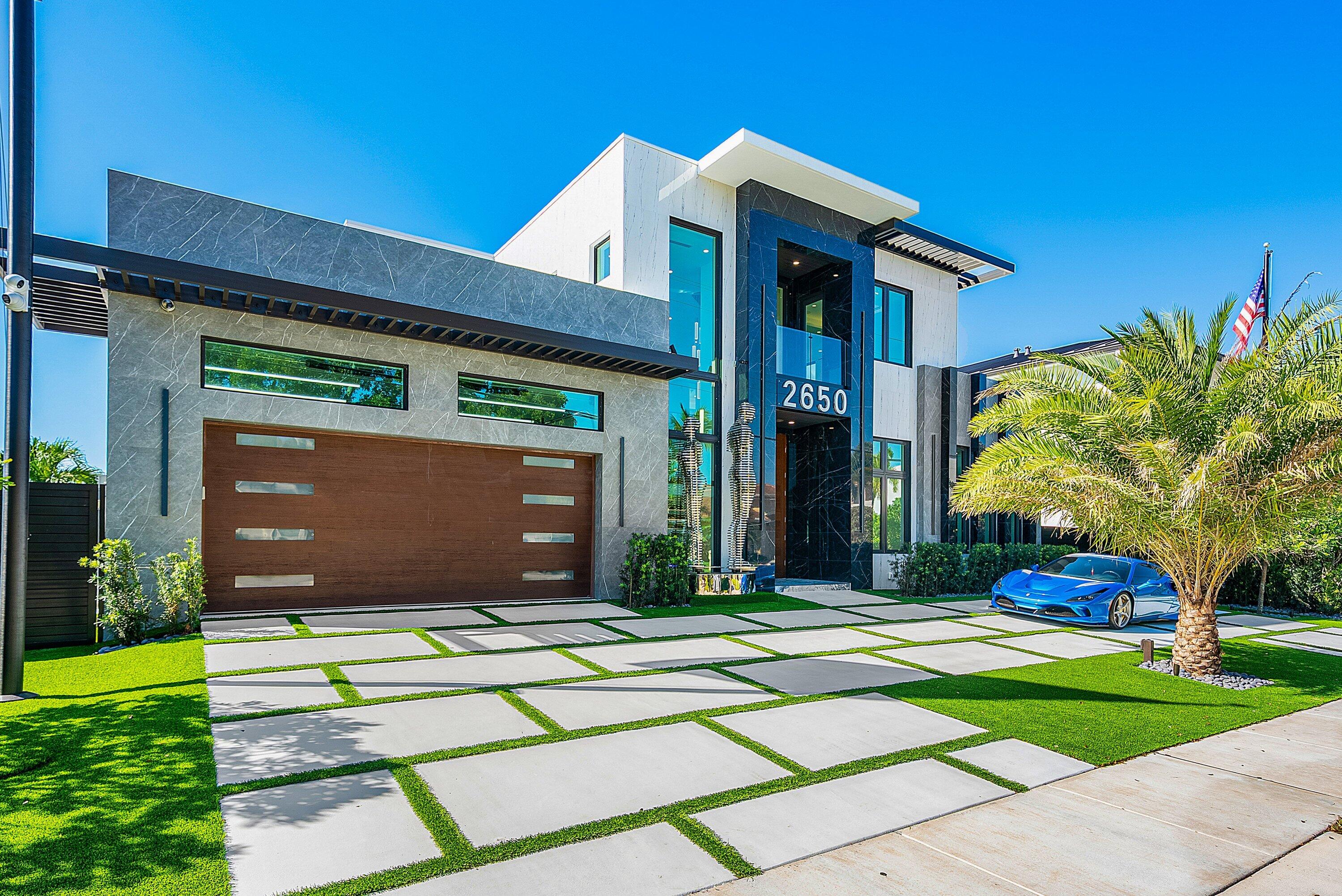 2650 Northeast 48th Court Lighthouse Point, FL 33064 - Photo 4 of 86 a front view of a house with garden