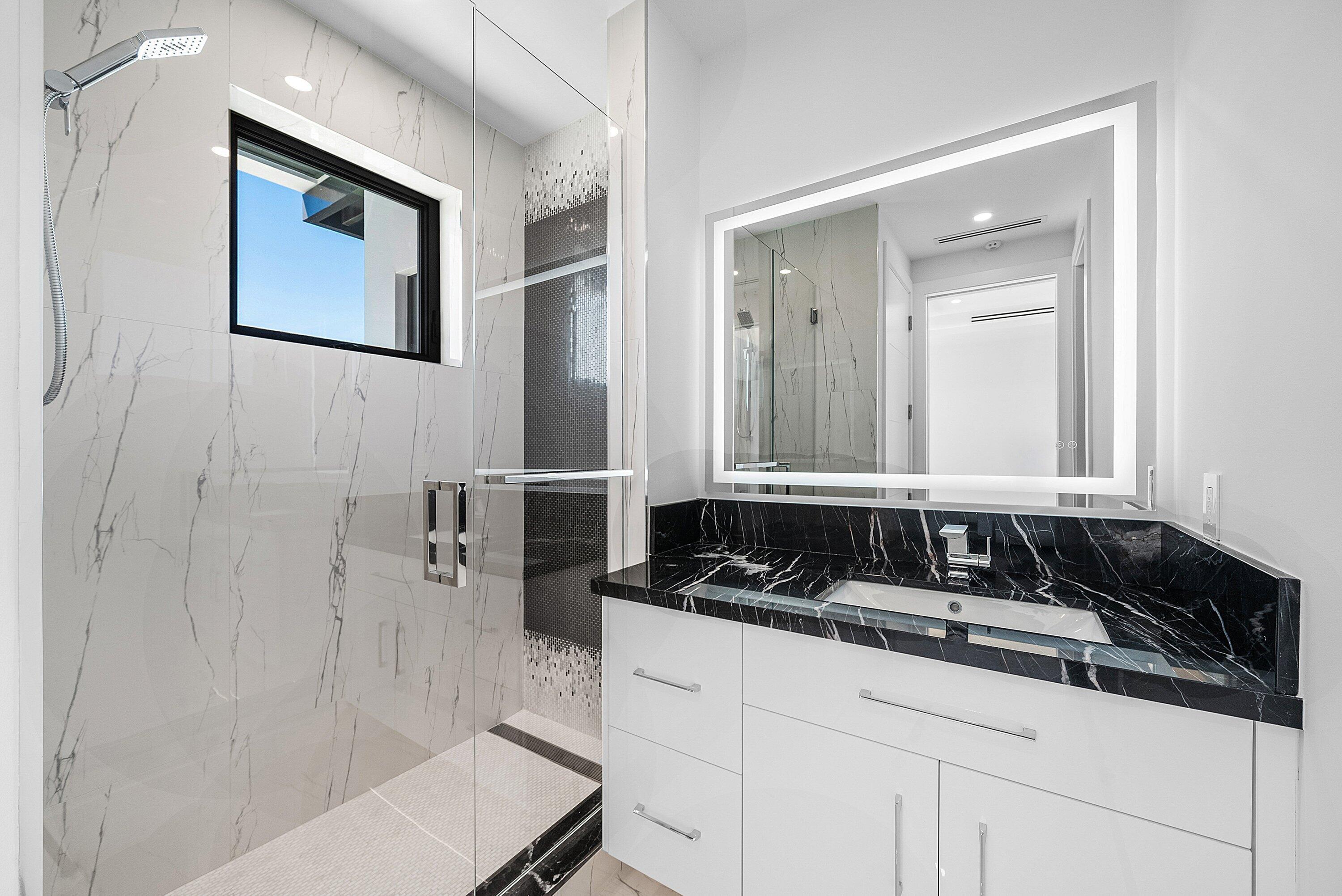 2650 Northeast 48th Court Lighthouse Point, FL 33064 - Photo 43 of 86 a bathroom with a sink and a mirror