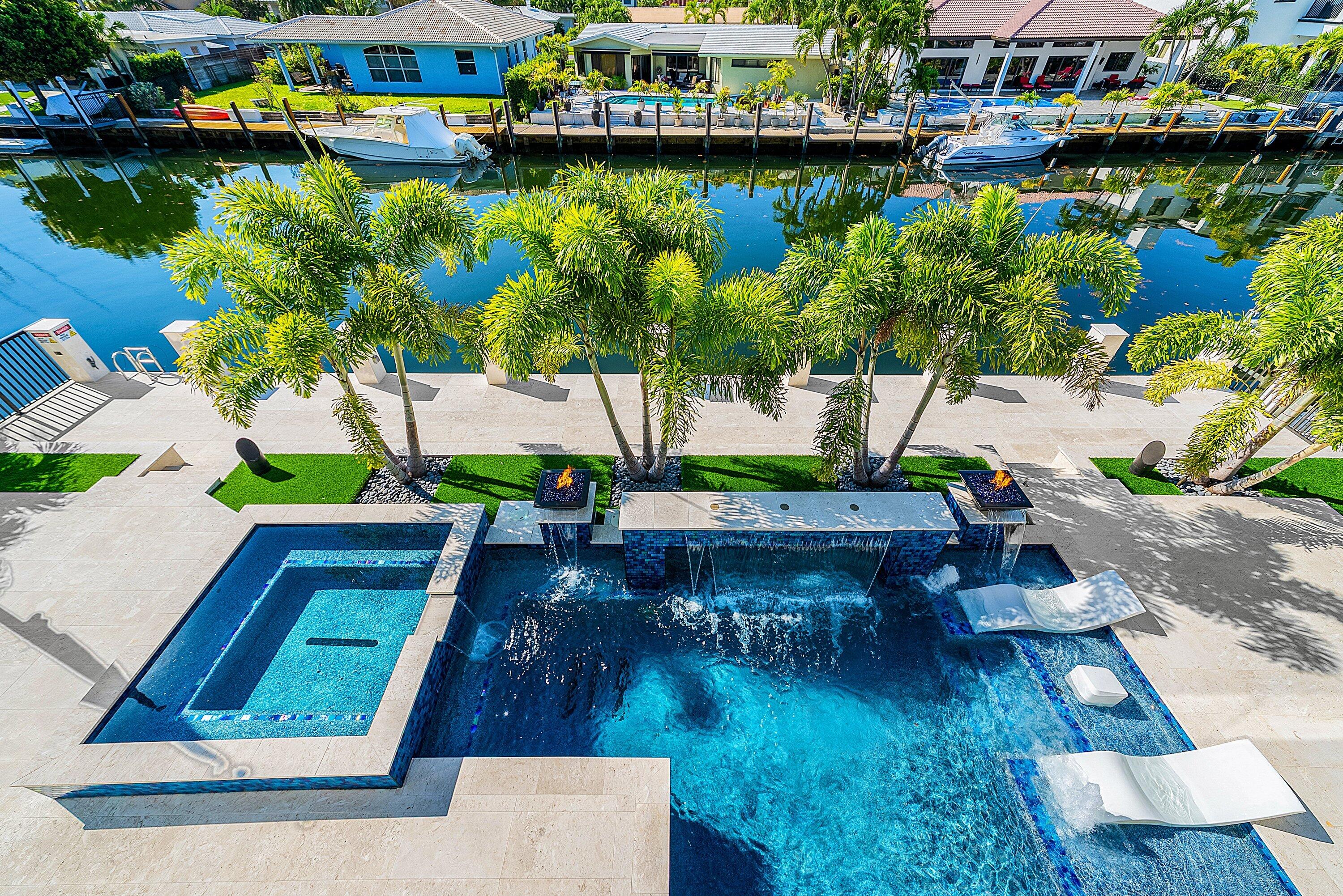 2650 Northeast 48th Court Lighthouse Point, FL 33064 - Photo 45 of 86 an aerial view of a house with swimming pool patio and outdoor seating
