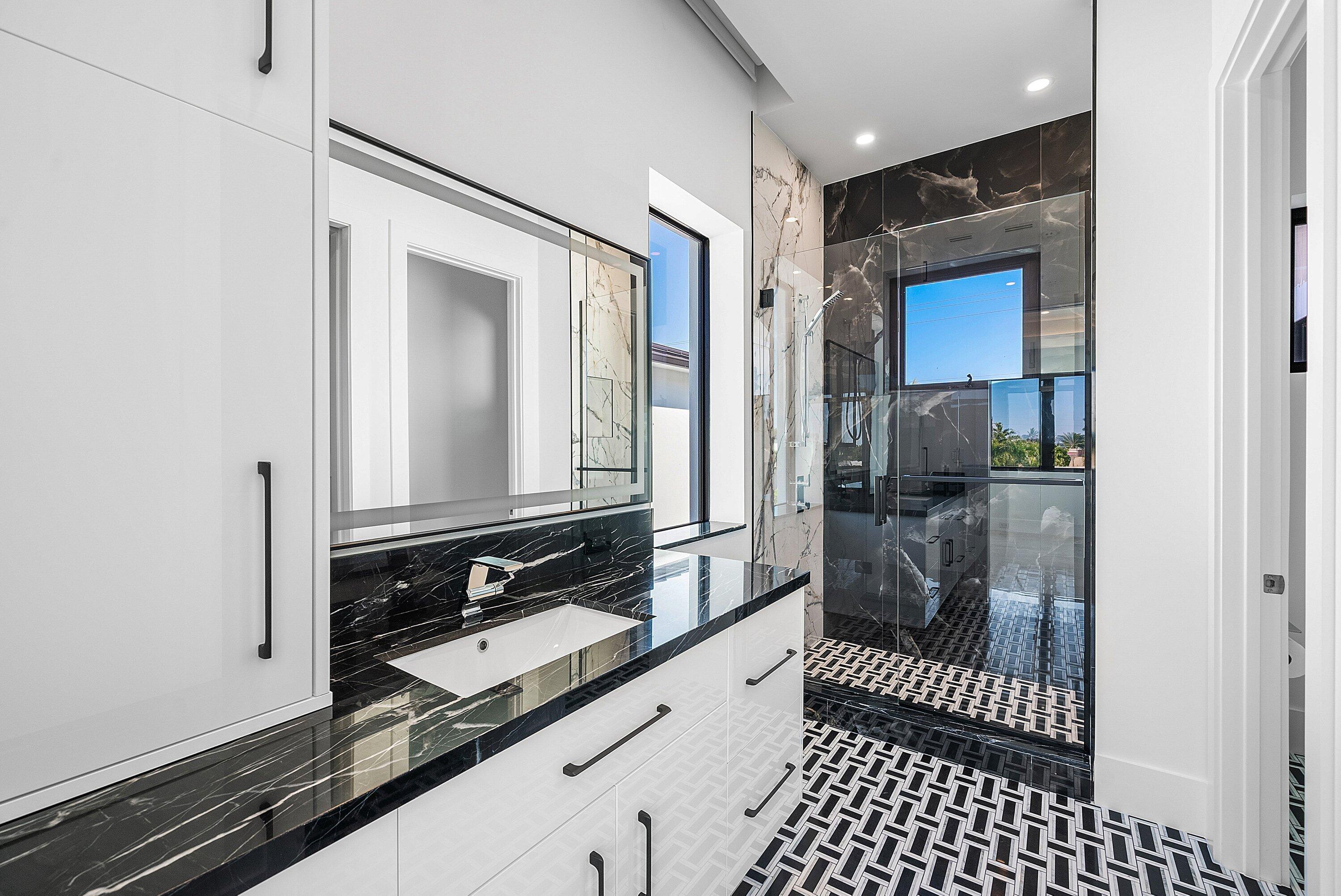 2650 Northeast 48th Court Lighthouse Point, FL 33064 - Photo 50 of 86 a bathroom with a sink and a mirror