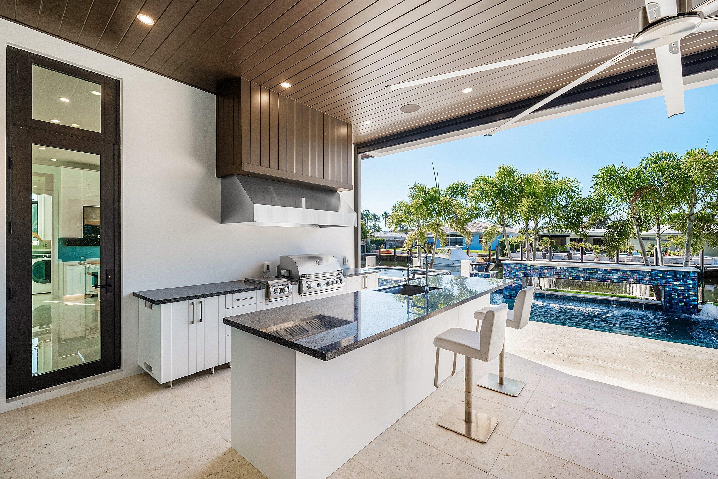 2650 Northeast 48th Court Lighthouse Point, FL 33064 - Photo 56 of 86 a kitchen with stainless steel appliances granite countertop a sink and a stove