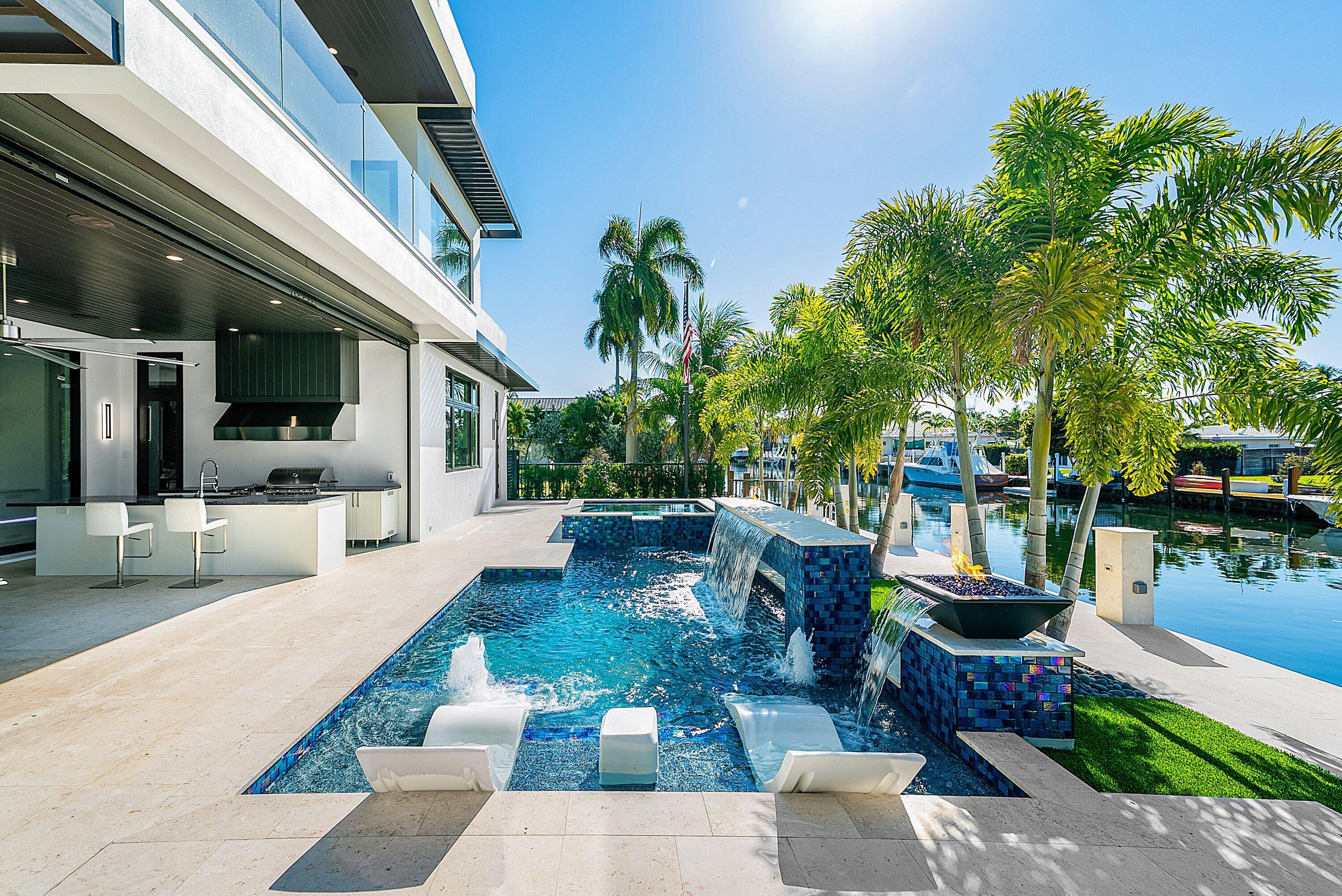 2650 Northeast 48th Court Lighthouse Point, FL 33064 - Photo 59 of 86 a view of a patio with couches table and chairs and potted plants