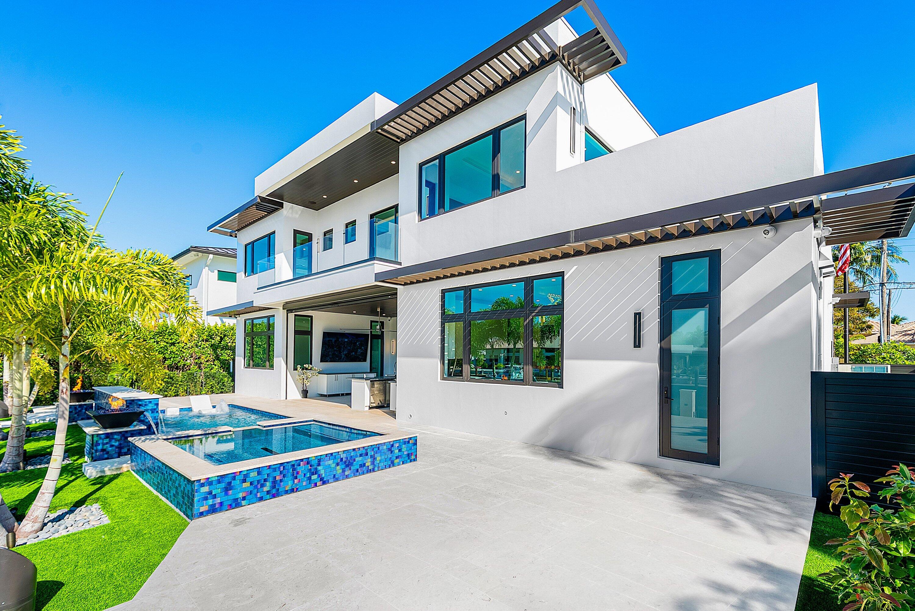 2650 Northeast 48th Court Lighthouse Point, FL 33064 - Photo 61 of 86 a front view of a house with garden