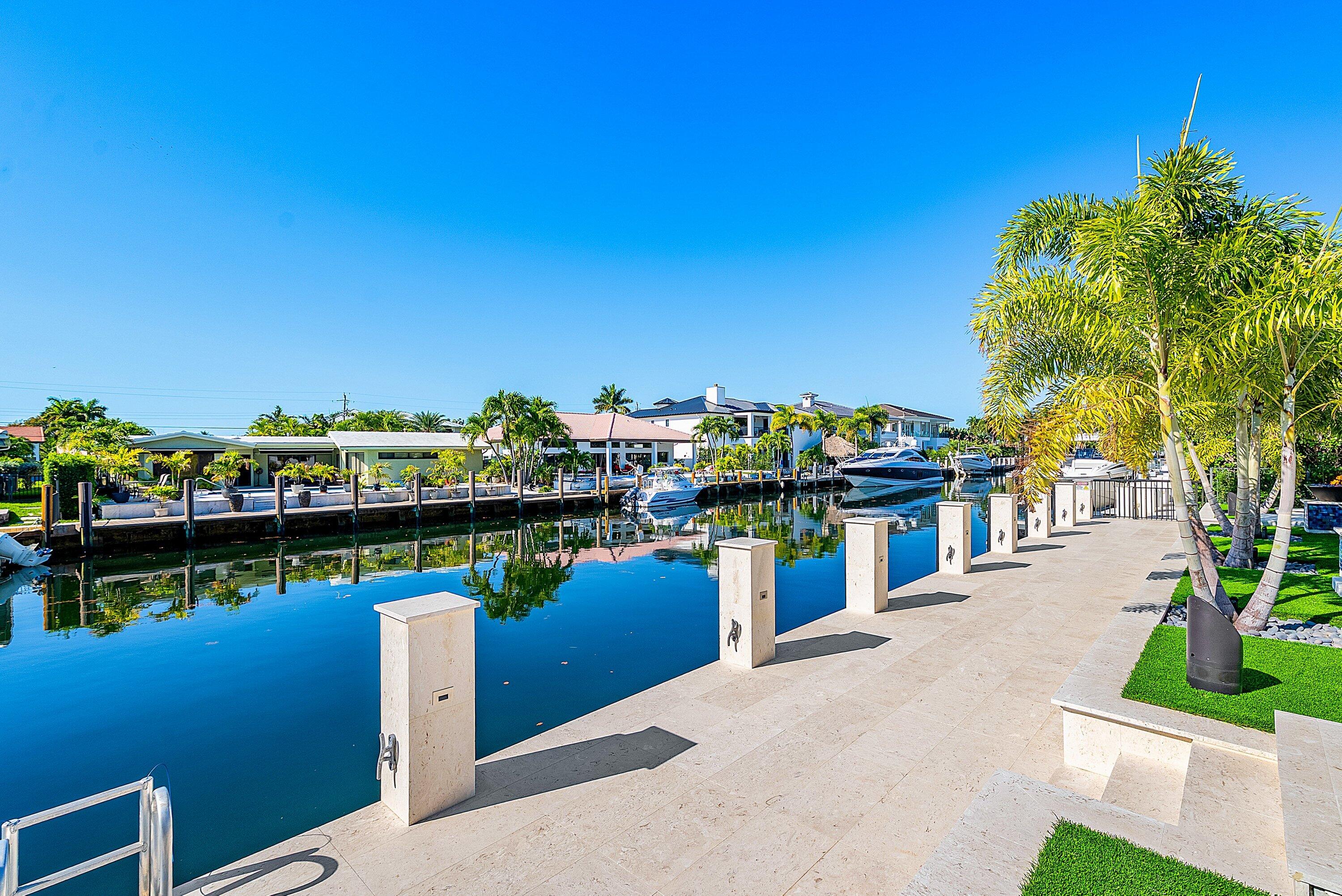 2650 Northeast 48th Court Lighthouse Point, FL 33064 - Photo 62 of 86 a view of a lake with a house
