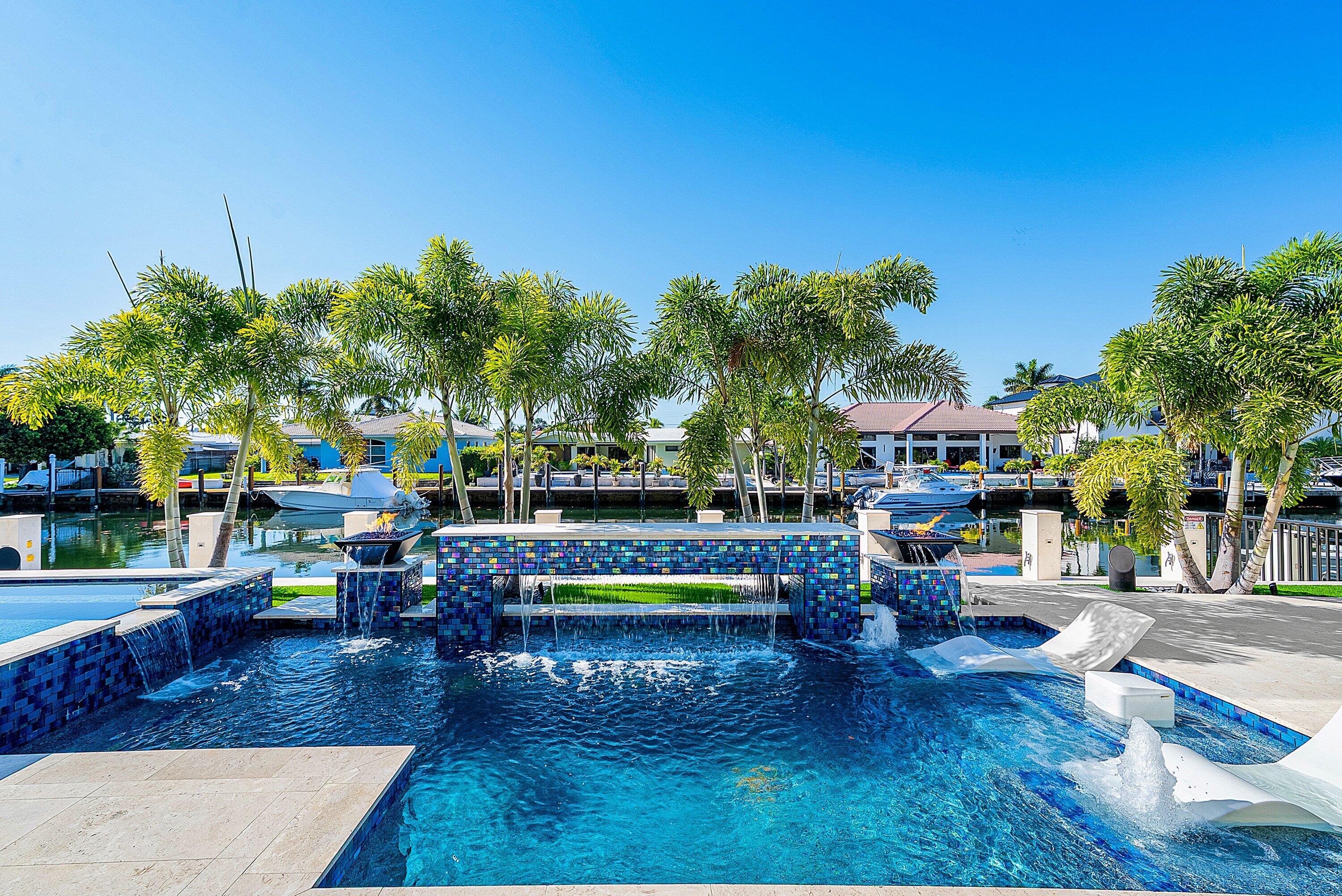 2650 Northeast 48th Court Lighthouse Point, FL 33064 - Photo 9 of 86 a swimming pool with outdoor seating and yard