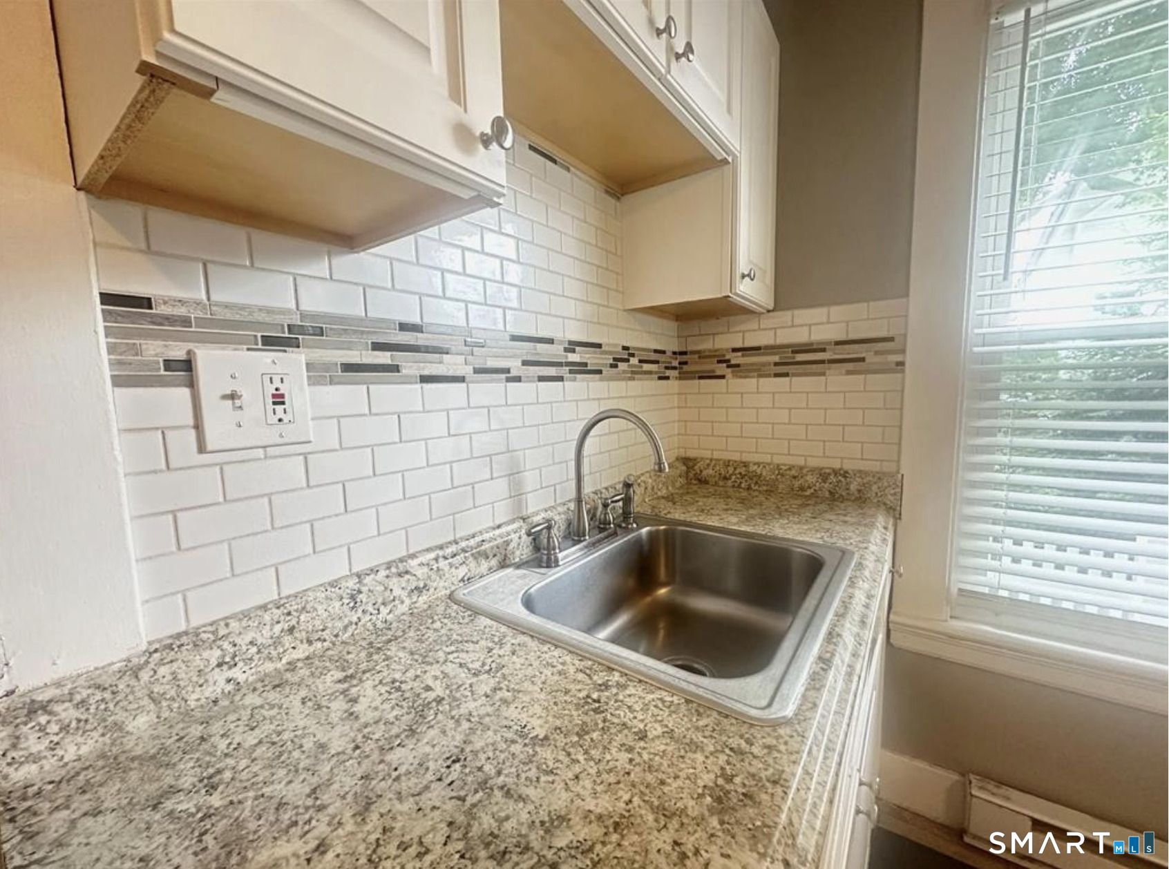 49 Dutton Street Wallingford, CT 06492 - Photo 3 of 10 a close view of sink and washing machine