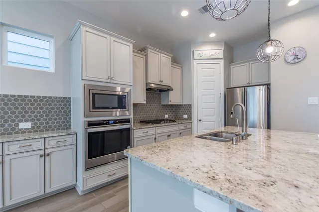 a kitchen with a refrigerator stove and sink