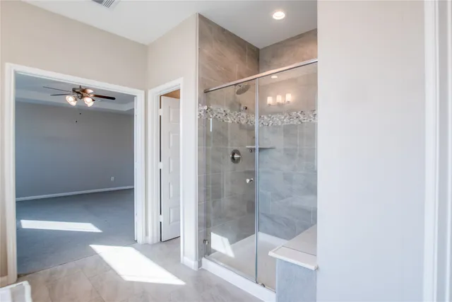 a bathroom with a glass shower door