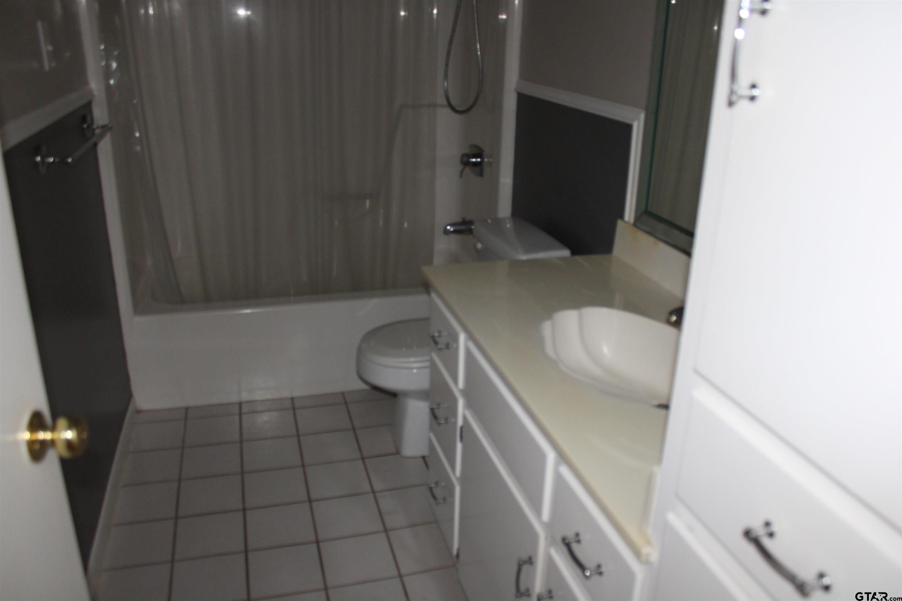 8202 Purdue Drive Tyler, TX 75703 - Photo 13 of 27 a bathroom with a sink and toilet