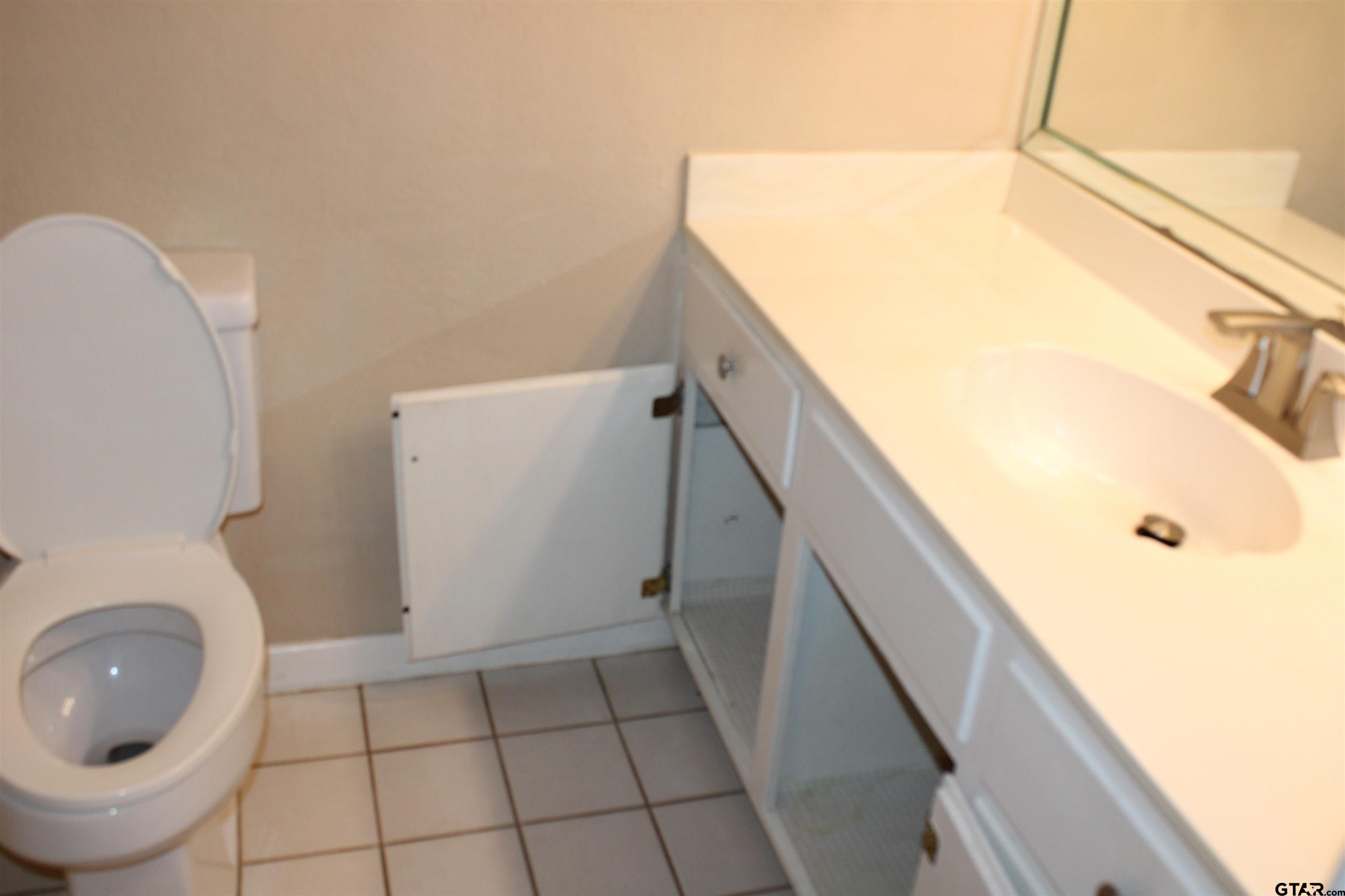8202 Purdue Drive Tyler, TX 75703 - Photo 22 of 27 a bathroom with a toilet and a tub