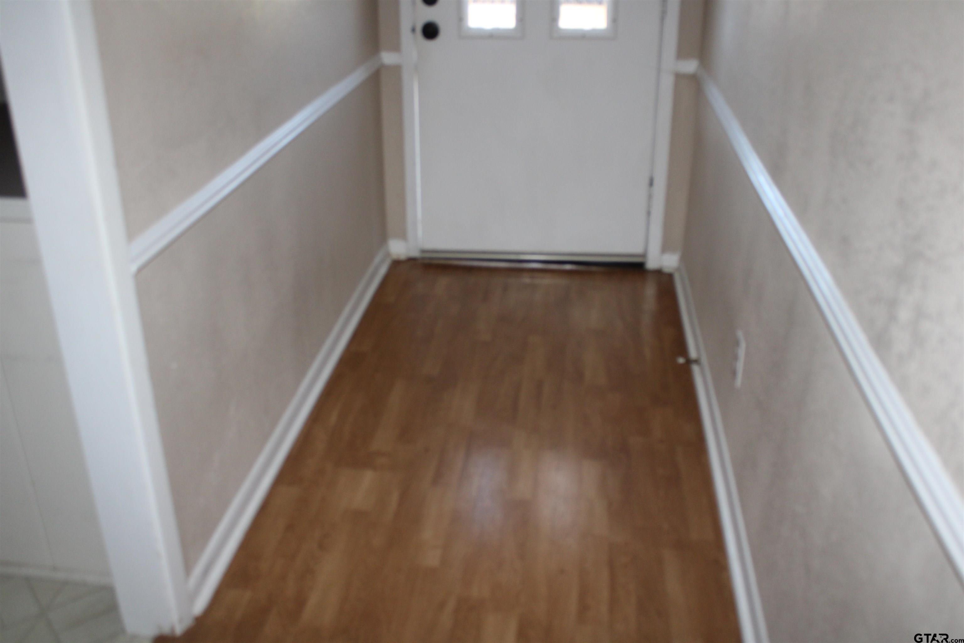 8202 Purdue Drive Tyler, TX 75703 - Photo 23 of 27 a view of a hallway with wooden floor and staircase