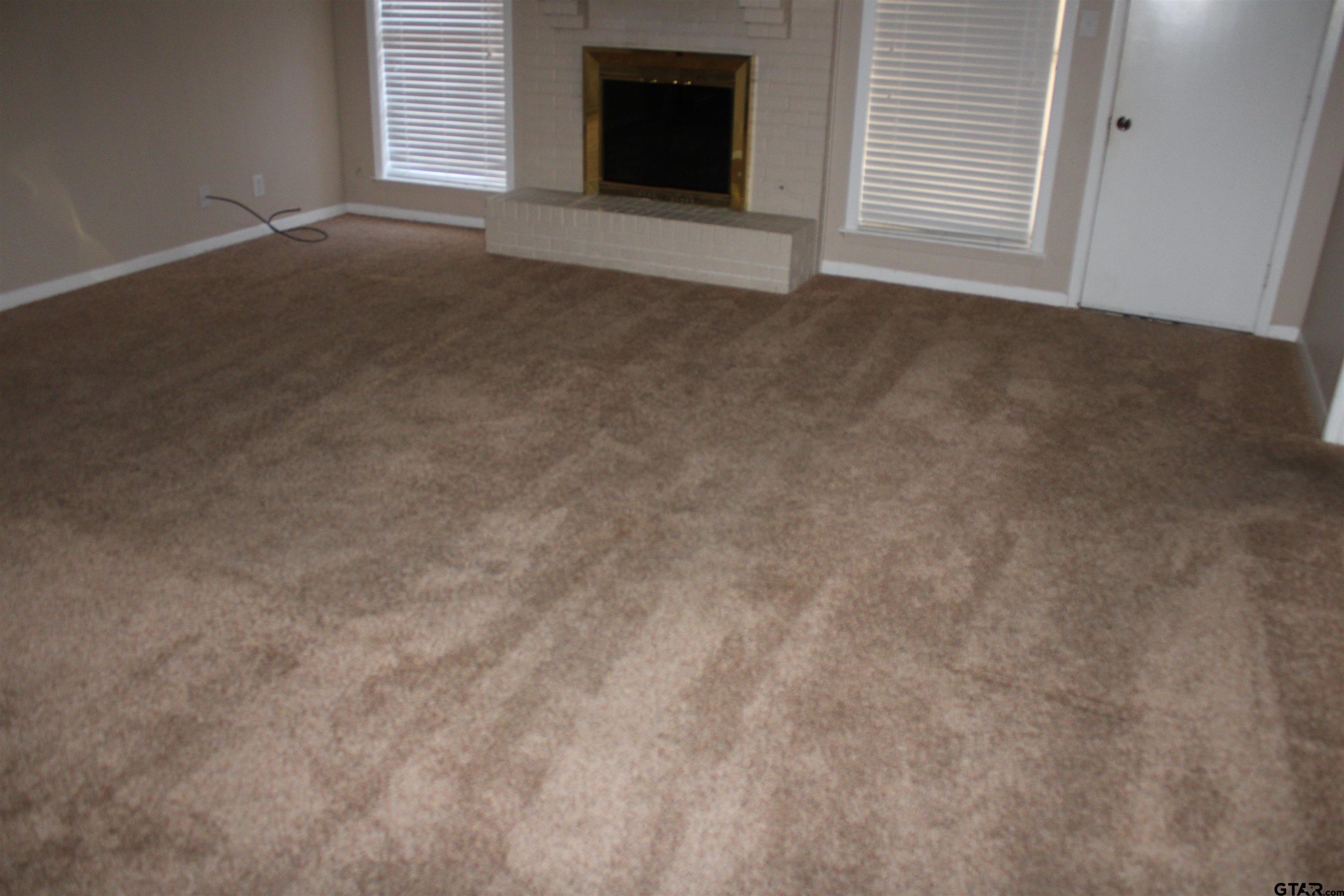 8202 Purdue Drive Tyler, TX 75703 - Photo 8 of 27 an empty room with a fireplace